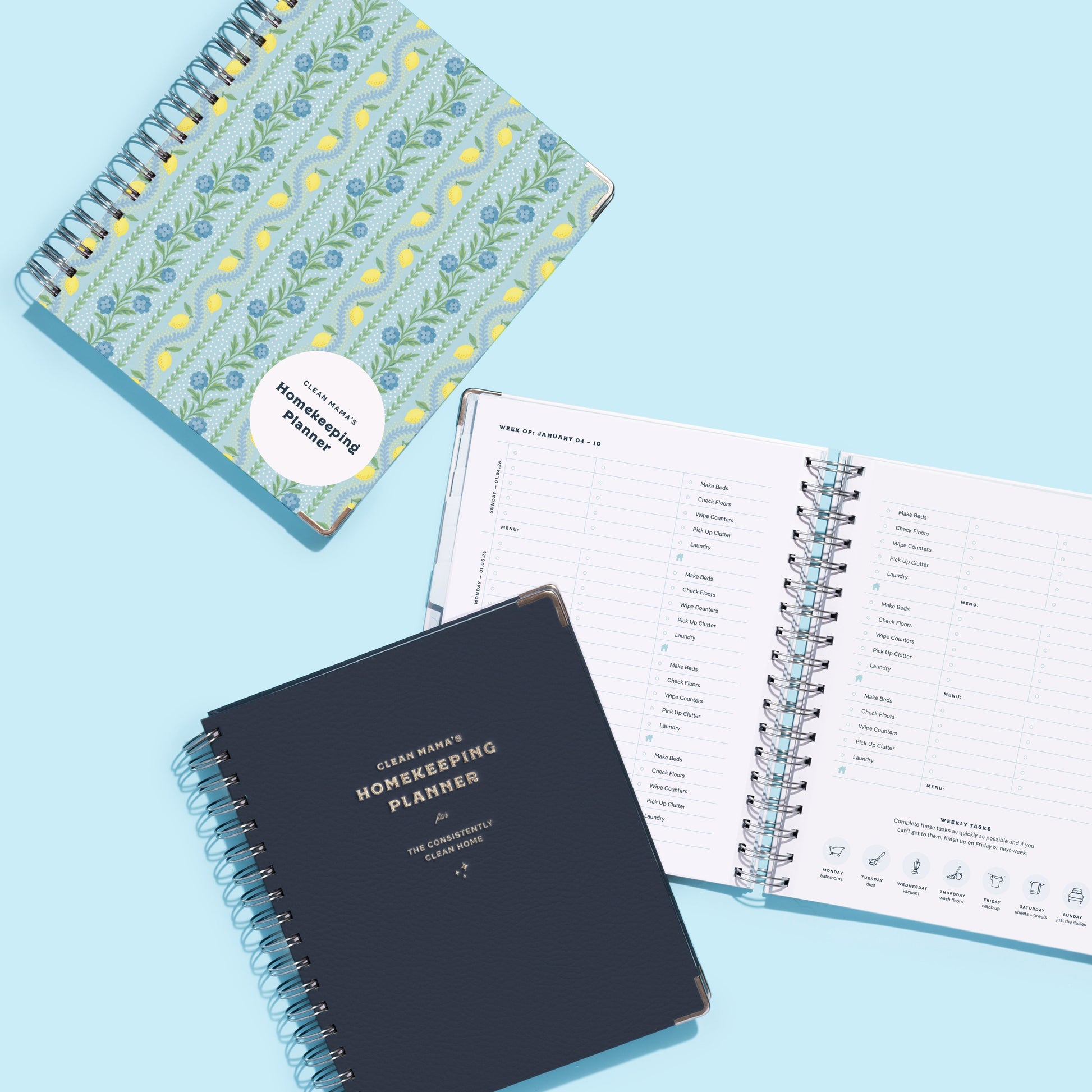 Two planners on a light blue background, one navy and one with floral design.