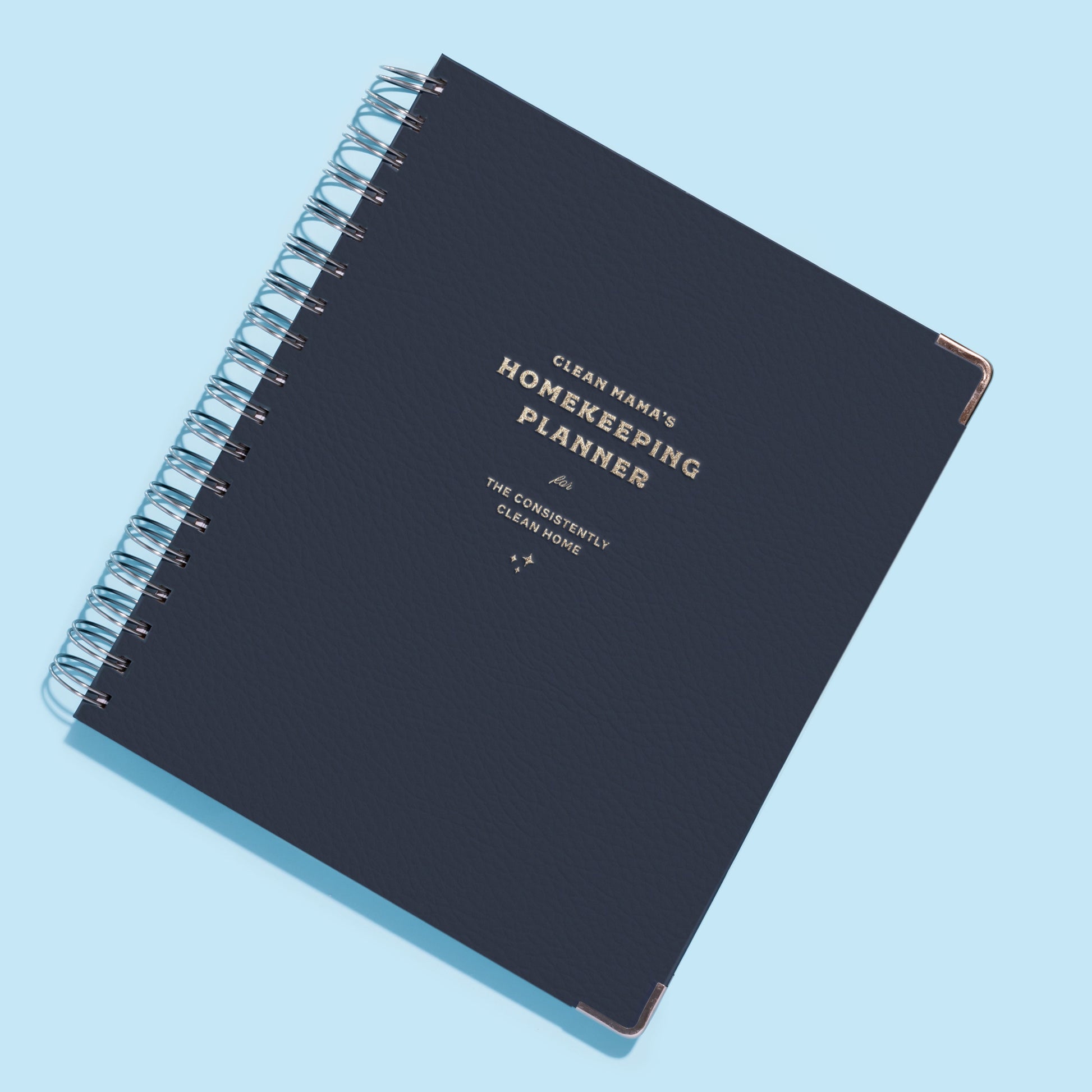 Navy homekeeping planner on a light blue background