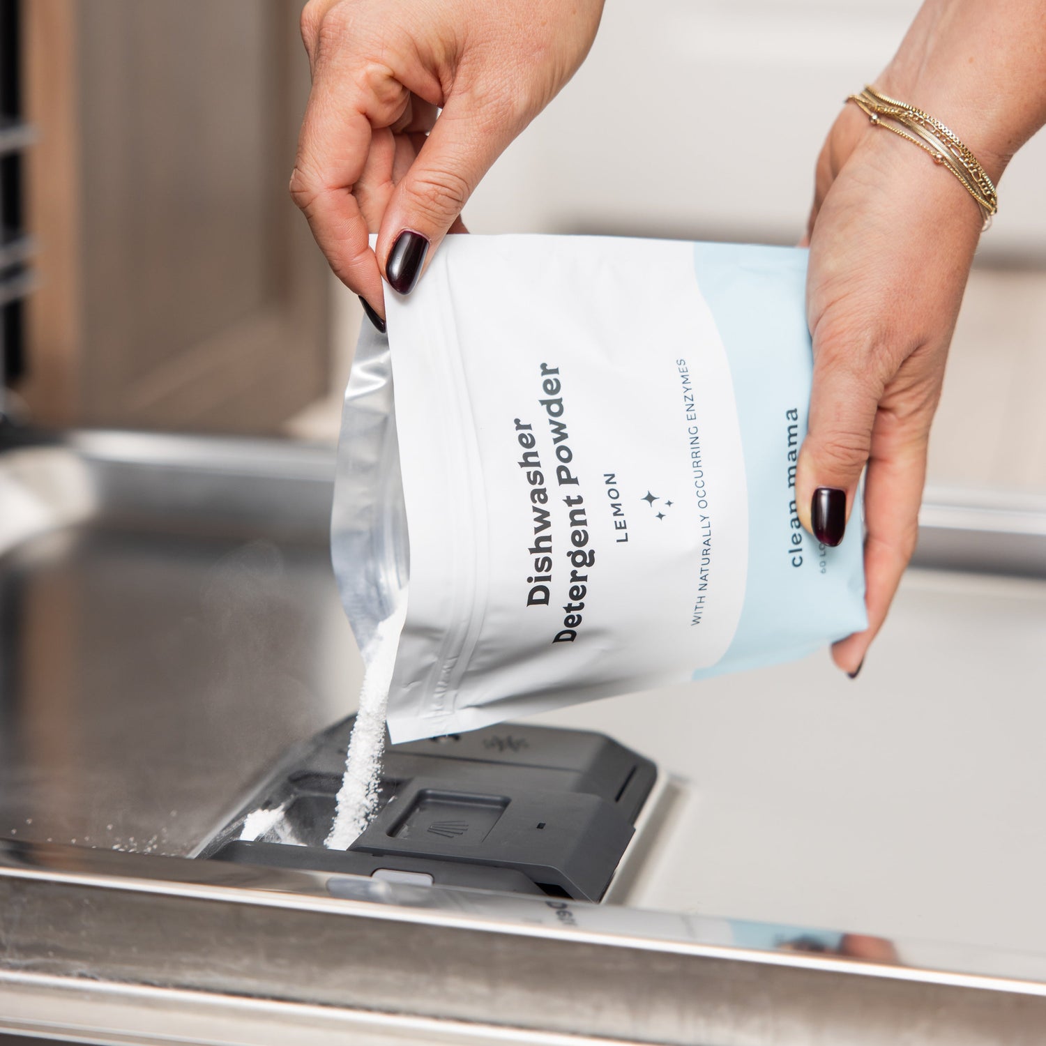 Person pouring dishwasher detergent powder into a dishwasher.